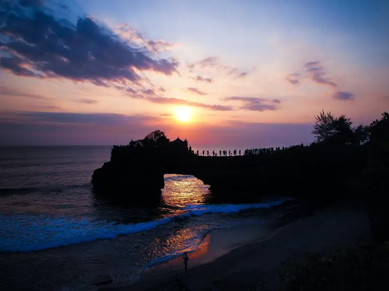 Several people watching the sunset from Batu Bolong Beach, Bali