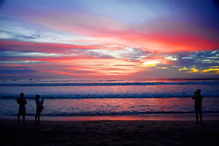 Several people enjoying the sunset on Kuta beach, Bali